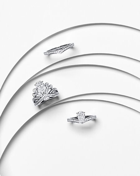 Chaumet Jos&eacute;phine diamond engagement rings and wedding band on a white layered background. 